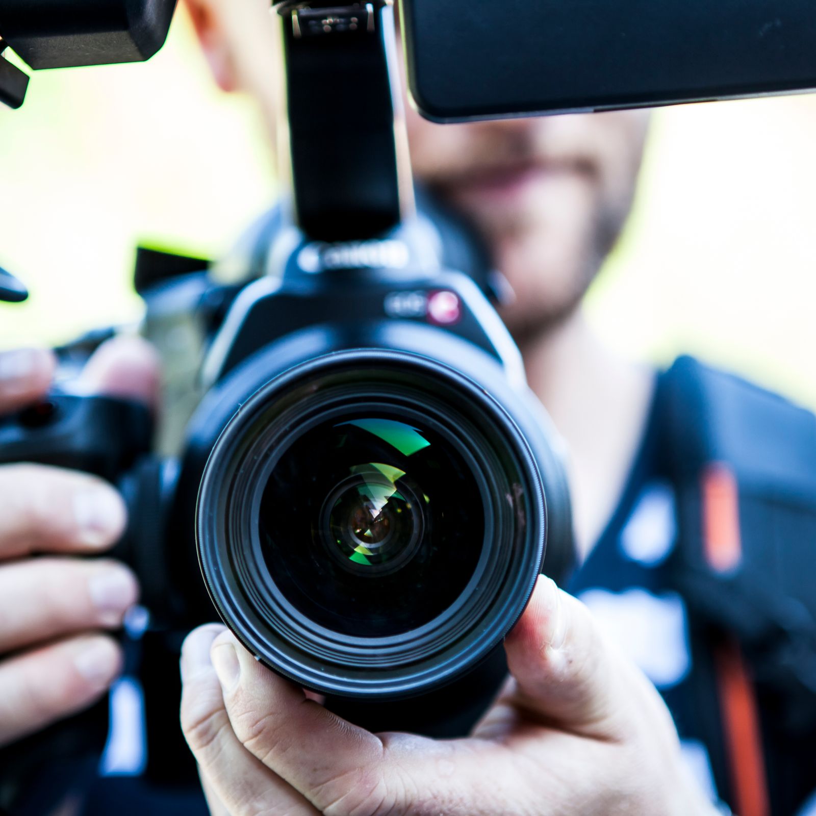 Editor framing a shot with a camera on location